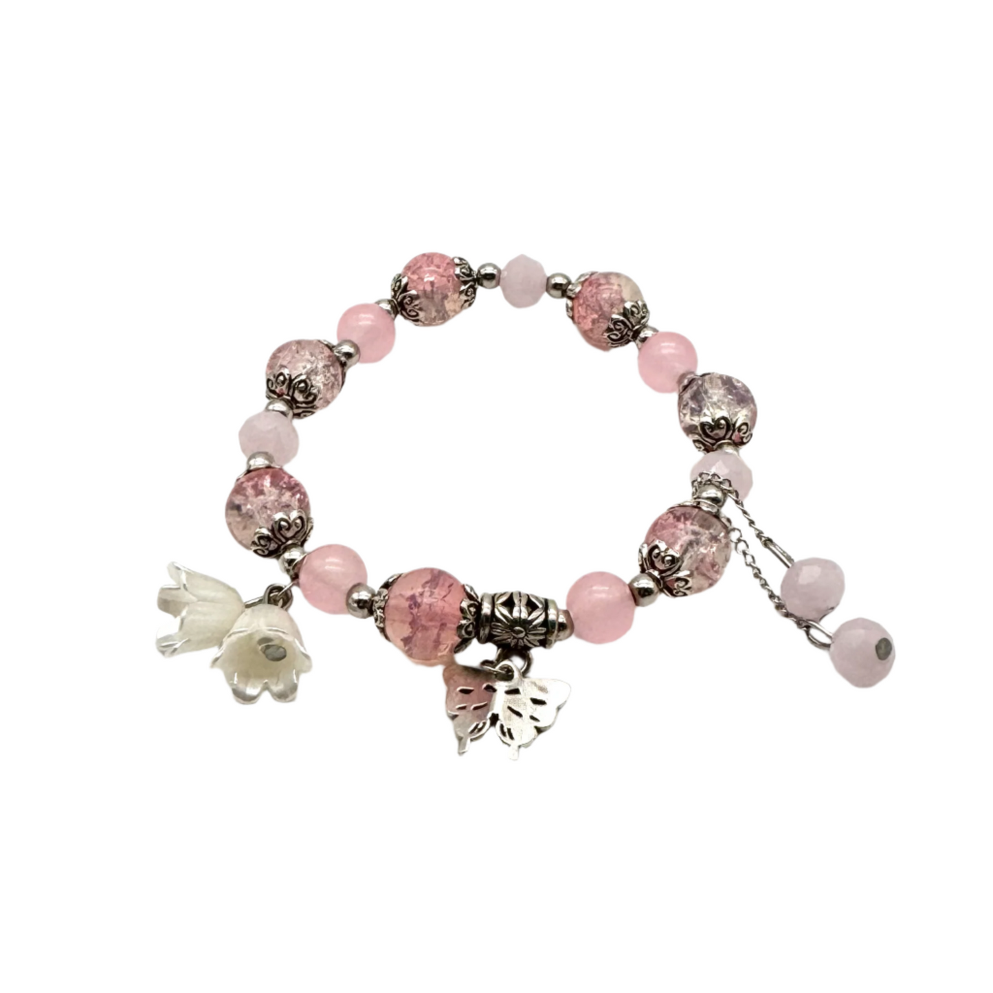 Roze kralen stretch armband met zilveren spacers en vlinder bedel